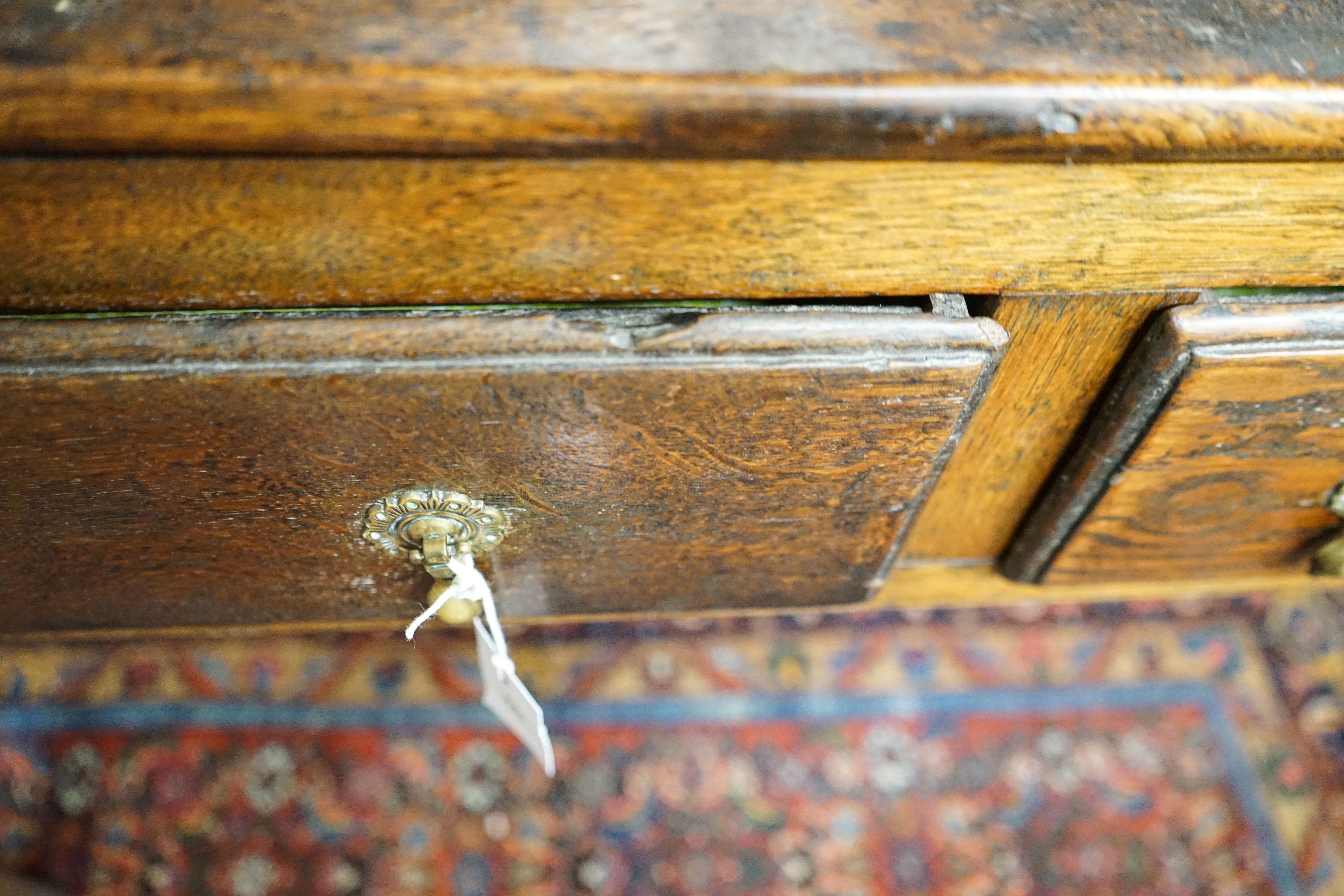 A George III oak dresser, with two shelf rack and three long drawers, on chamfered legs, width 167cm, depth 49cm, height 193cm